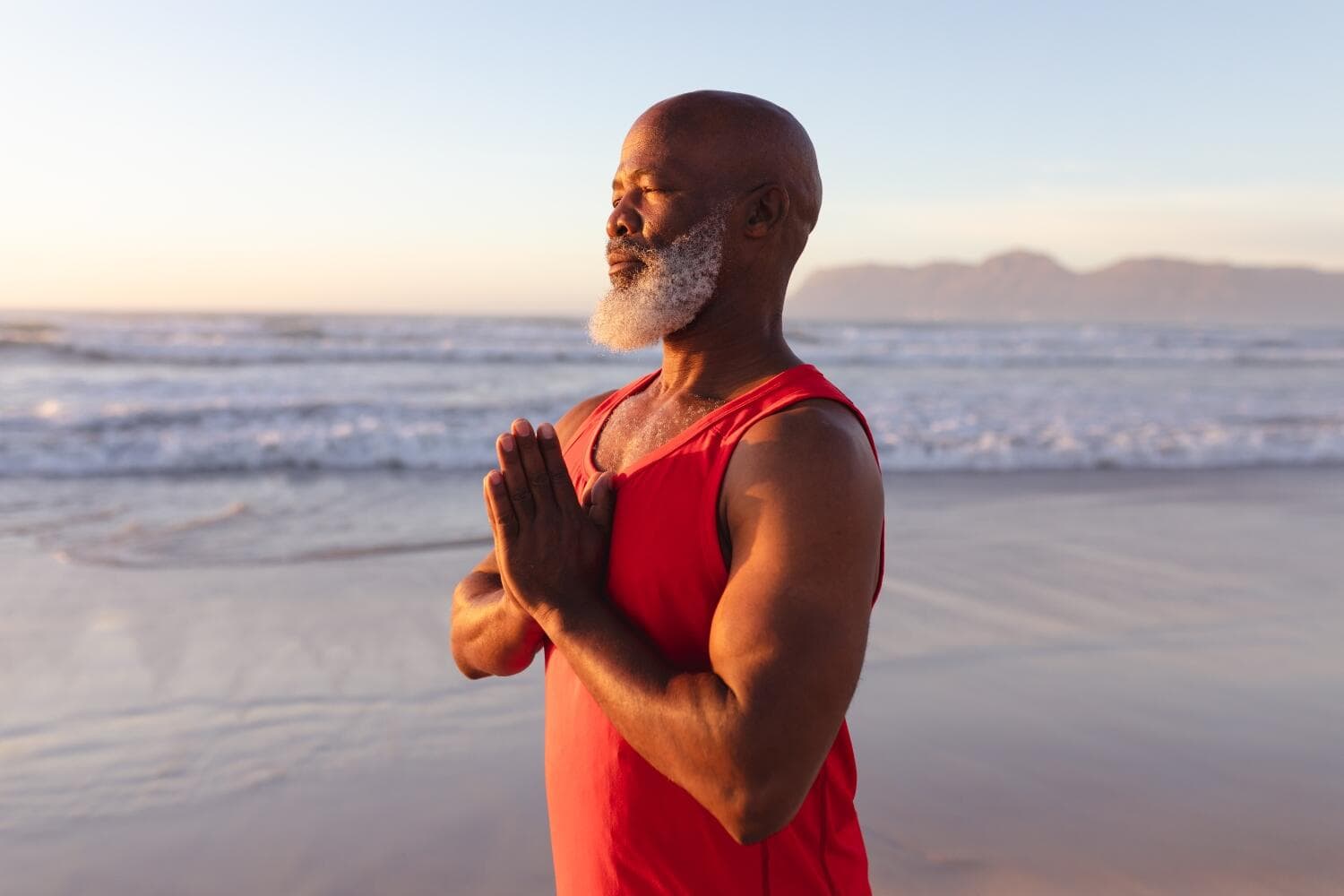 adult black man doing meditation by the beach adult black man doing meditation by the beach