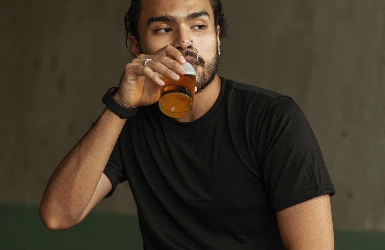 Man struggling with addiction to alcohol