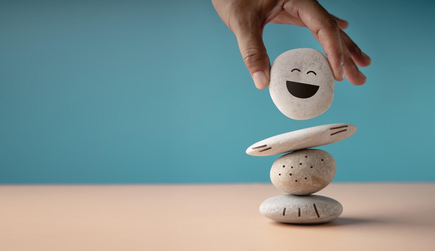 Enjoy Life Concept. Harmony and Positive Mind. Hand Setting White Natural Stone Stack to Balance Enjoying Life Concept. Harmony and Positive Mind. Hand Setting White Natural Stone Stack to Balance. Balancing Body, Mind, Soul and Spirit. Mental Health Practice