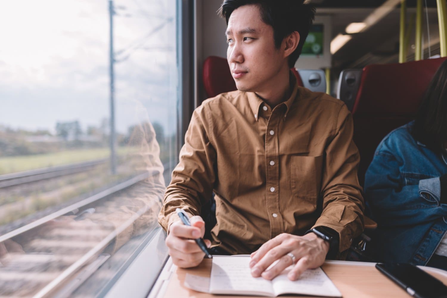 Man writing on notebook